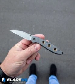 WE Knife Co. Schism Frame Lock Knife Gold Holes (2.8" Stonewash) 908A -Benchmadess Zone WE Knife Co Schism Frame Lock Knife Gold Holes Stonewash 908A BHQ 97974 kp in hand web 2